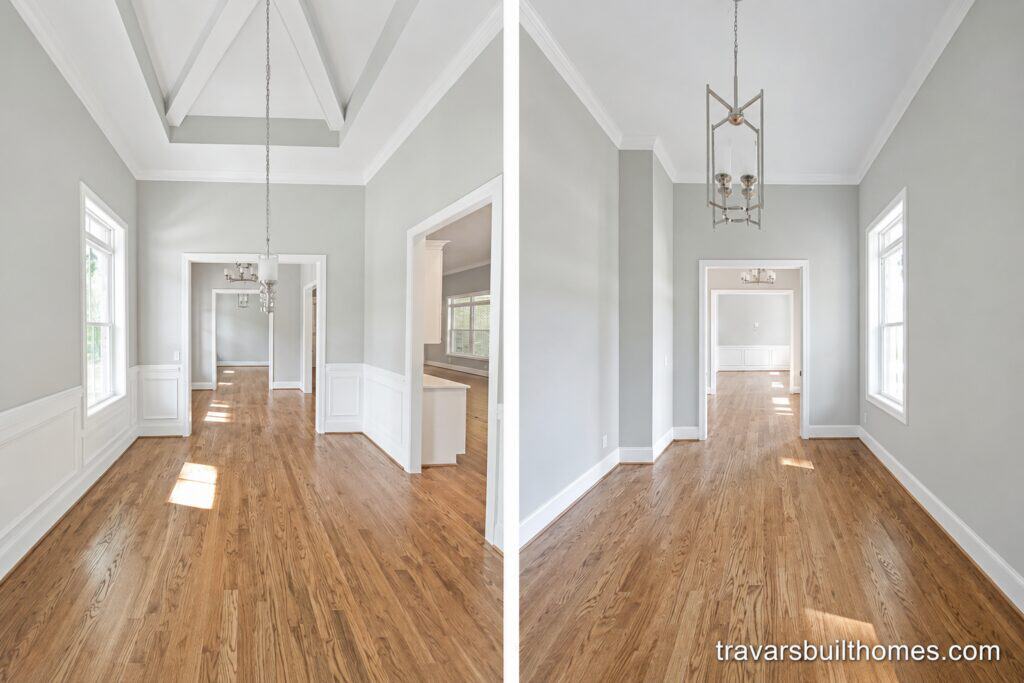 Open formal dining space highlighting elegant white wainscoting paneling, a distinctive vaulted tray ceiling with architectural beams, a modern chandelier, and rich hardwood flooring, crafted by Travars Built Homes.