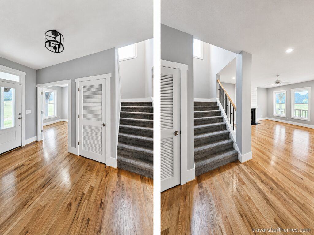 View of a custom interior entryway with hardwood floors, highlighting a carpeted staircase that frames an open view into a large, vaulted living room, built by Travars Built Homes.