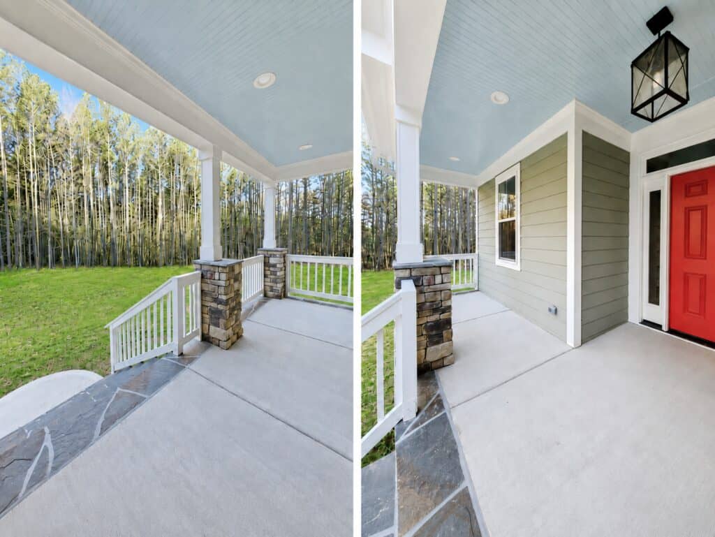 Welcoming custom home front porch highlighting a light blue painted ceiling, white columns with stone bases, a concrete floor with a stone border, and a bold red front door, by Travars Built Homes.
