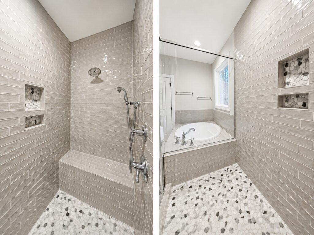 Custom luxury master bathroom showcasing a walk-in shower with wavy gray subway tile and built-in niches, alongside a built-in soaking tub, crafted by Travars Built Homes.