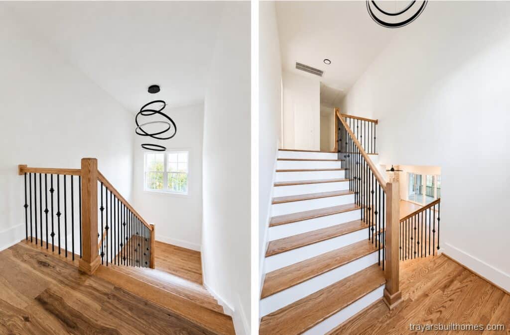 Custom home wooden staircase featuring stained oak treads, white risers, dark iron balusters, and a contemporary ring chandelier, highlighting interior design by Travars Built Homes.